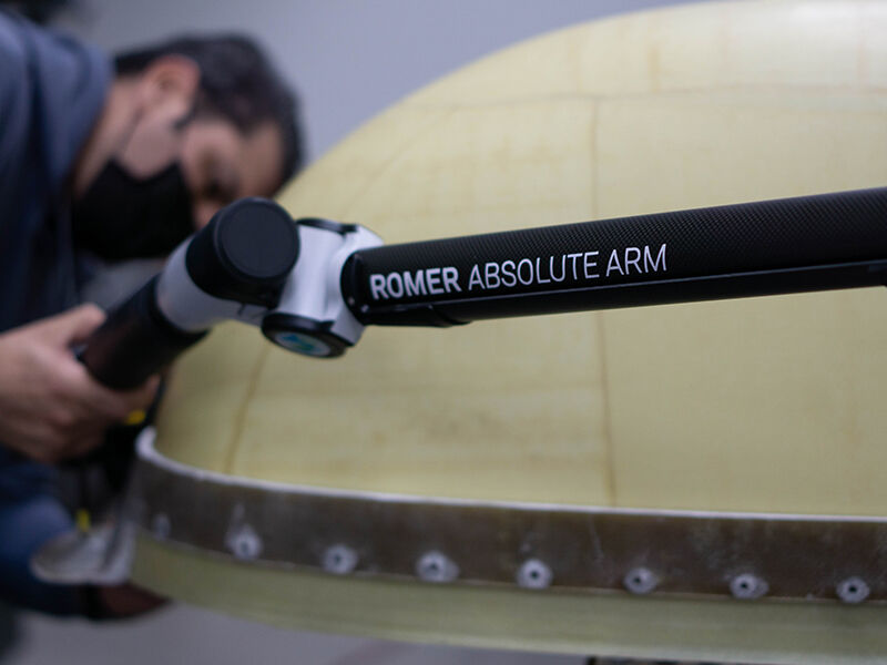 Image of the Romer Absolute Arm being used by a technician during the quality inspection of a large radome.